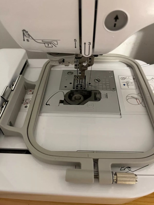 4×4 hoop attached over the needle plate and drop-in bobbin area.