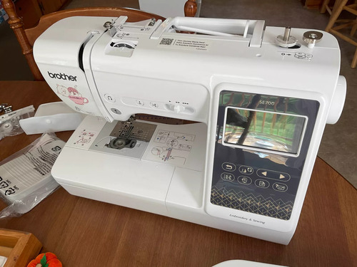 table—touch-screen display, needle plate, and free-arm clearly visible.