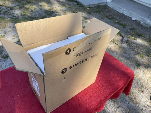 Unboxing machine – cardboard packaging with protective foam on outdoor table