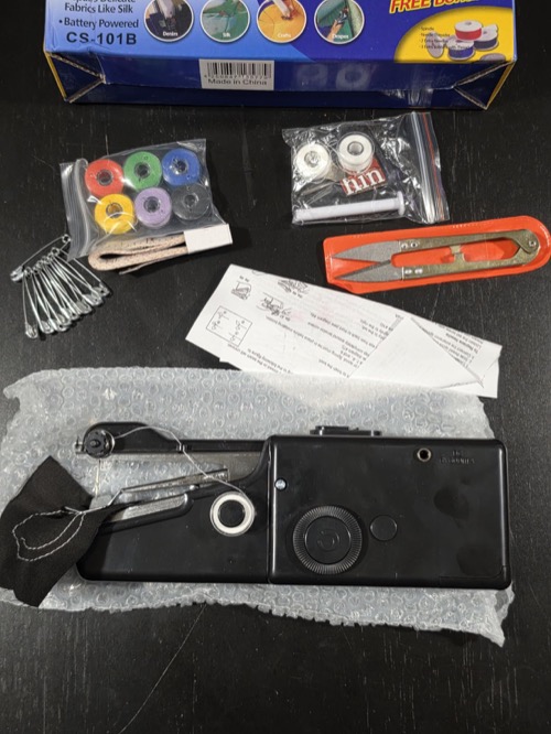 Customer photo of a black handheld stitcher with repair-kit accessories