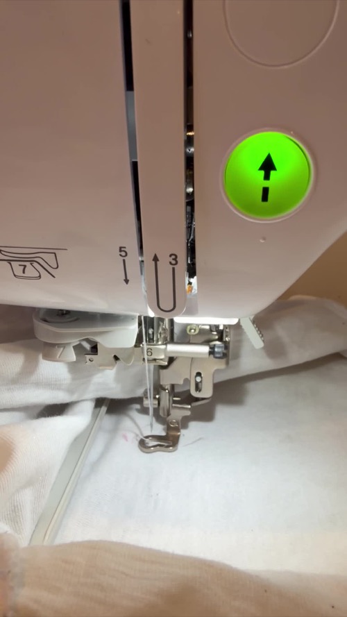 Close view of the Brother PE545 needle, presser foot and hooped fabric area