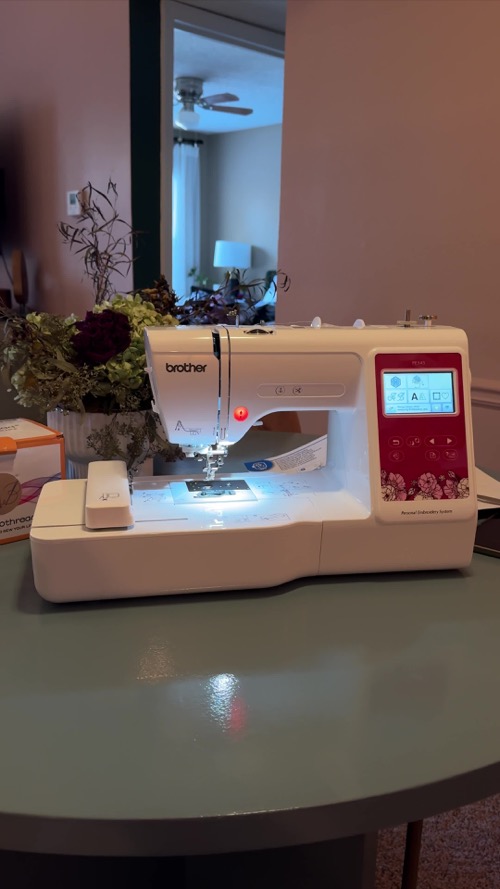 Brother PE545 set up for embroidery on a home worktable