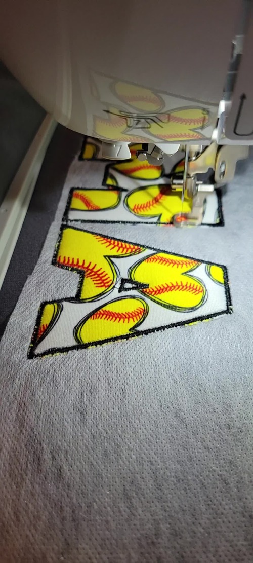 Lettering being embroidered on fabric with the Brother SE2000
