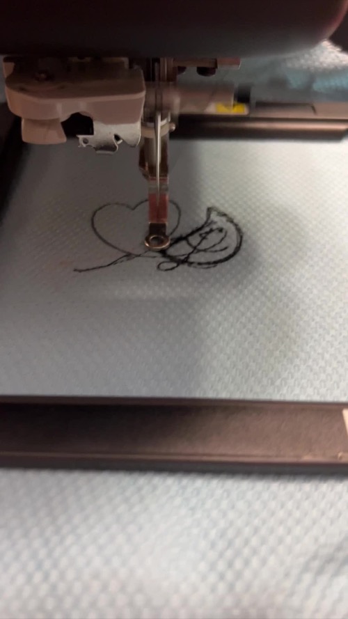 Tangled black thread visible beneath the Brother Skitch embroidery needle