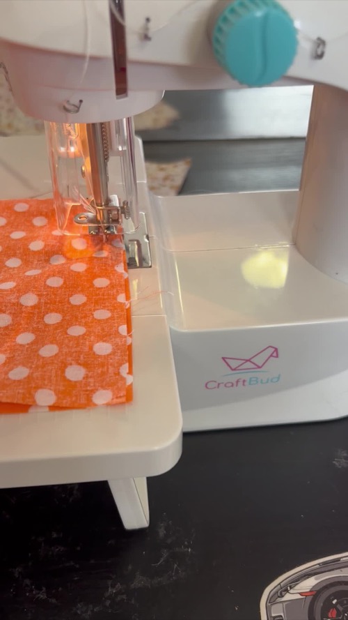 Orange fabric beneath a CraftBud mini machine during a customer-reported jamming problem