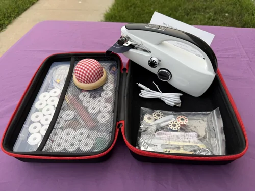 Customer photo of the XUEGUNIANG handheld beside its open black case and supplies