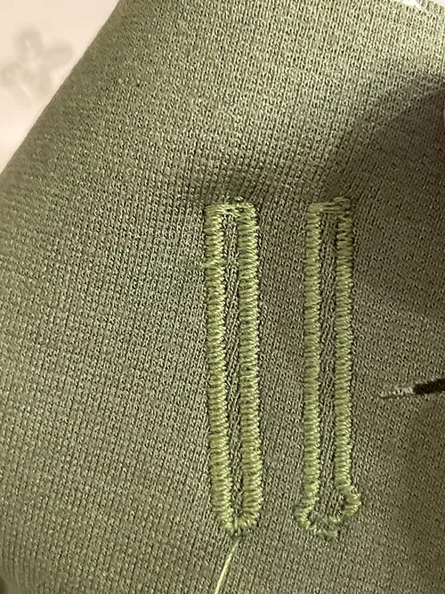 Close-up from an owner who reported inconsistent buttonholes.
