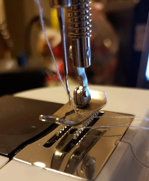 An owner’s close-up of the Magicfly needle and thread path.