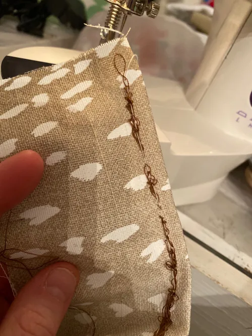 Looped stitching photographed by a Flying Banana 202 owner who struggled with setup and returned the machine; the underlying cause is unconfirmed.