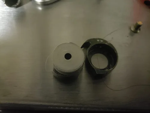 Bobbin and bobbin case resting on the metal base of the ColouredPeas patcher
